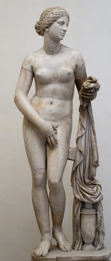 Aphrodite is depicted in a graceful contrapposto pose, preparing to bathe, with her right hand covering her pubic area and left hand holding drapery.