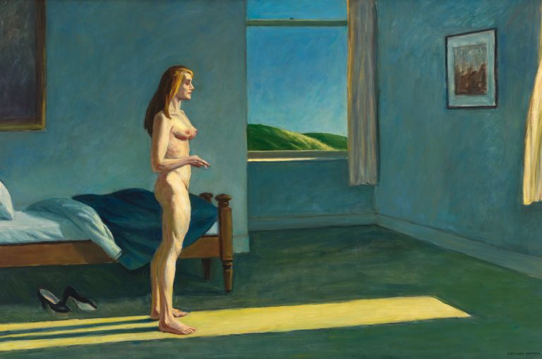 A nude female stands in a shaft of raking light from a nearby window