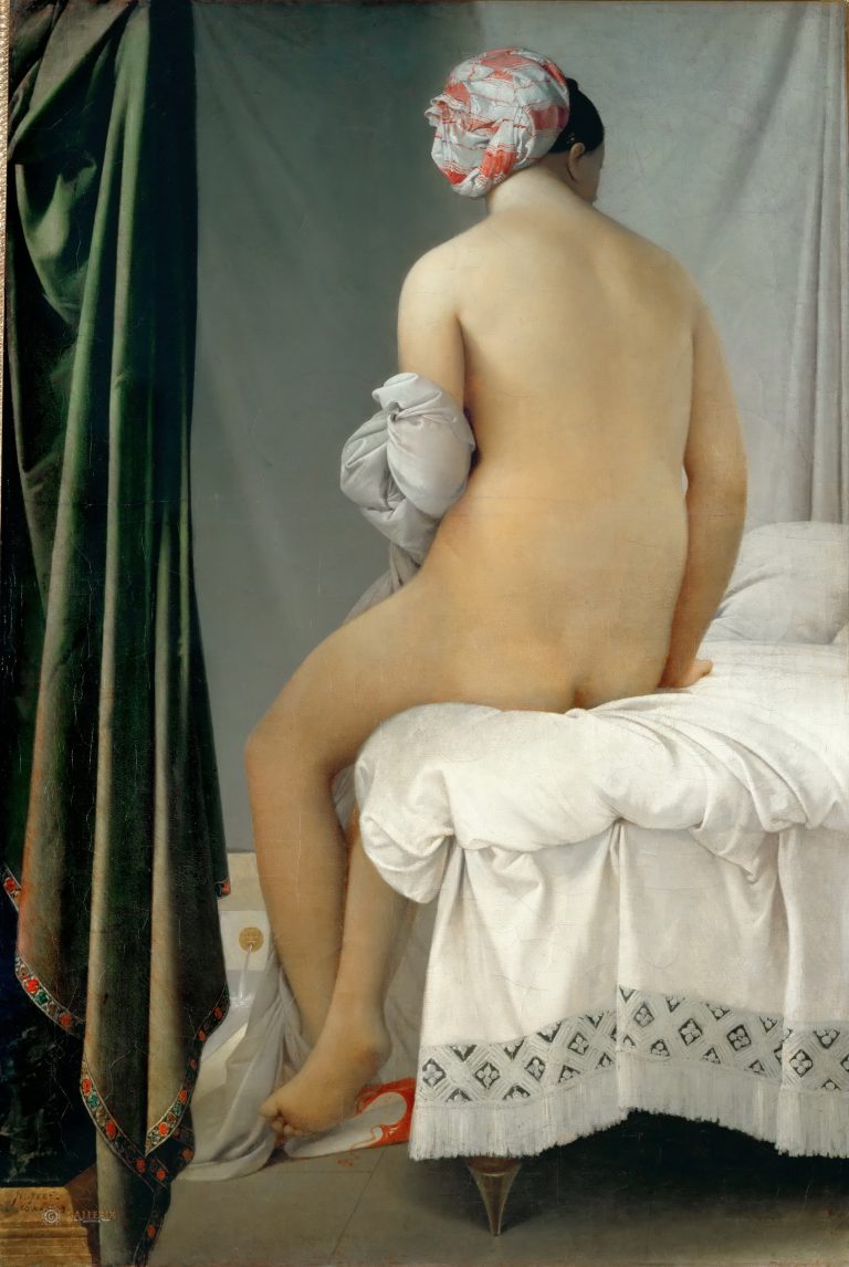A seated female nude from behind in a serene, intimate moment, characterized by soft lighting