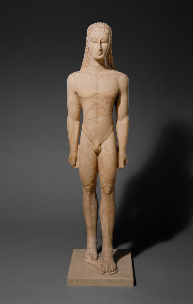 A nude statue of a kouros youth standing in a rigid, frontal pose with clenched fists and one foot forward, heavily influenced by Egyptian art, serving as a grave marker