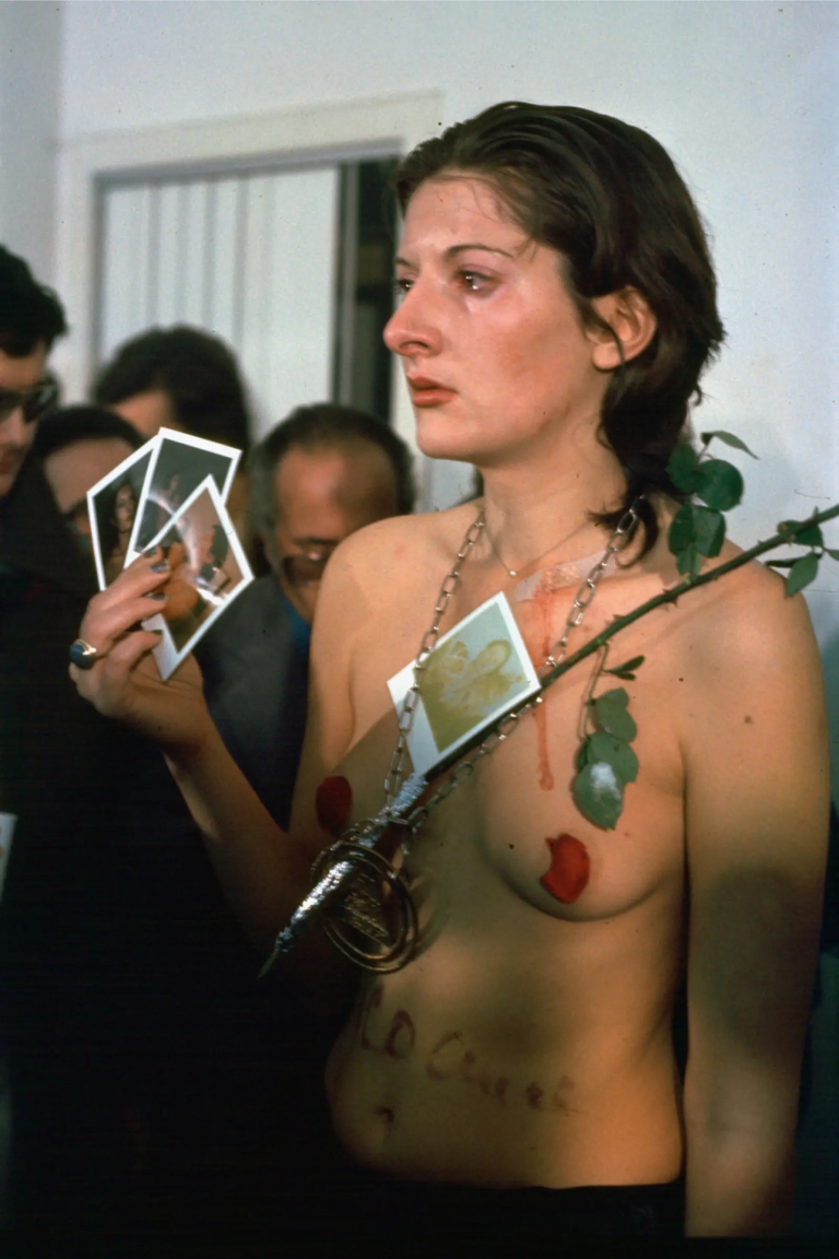 performance documentation showing the artist standing passively in a gallery for six hours while viewers were invited to use 72 objects on her body, including nudity and exposure to potential harm